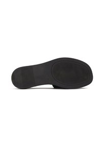 Black rubber shoe sole with textured grip patterns. Rounded shape and smooth edges. Size 38 indicated on the sole.