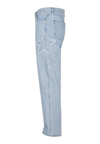 Light blue denim jeans featuring a large star appliqué on one leg, distressed detailing, and a slightly tapered fit with paint splatter accents.