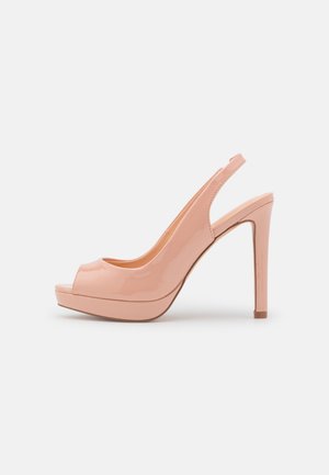Nude laklæder højhælet slingback-sko med åben tå og platformsål, vist i sideprofil på hvid baggrund.
