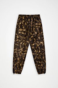 Φόρμες με ελαστική μέση σε σκούρο καφέ και χρυσό μοτίβο tie-dye, με φερμουάρ στους αστραγάλους και ελαφριά, γυαλιστερή υφή υφάσματος.