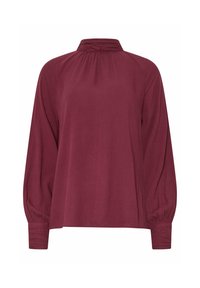 Blusa bordeaux a maniche lunghe con colletto alto, scollatura plissettata e polsini arricciati. Realizzata in un tessuto leggero e testurizzato.