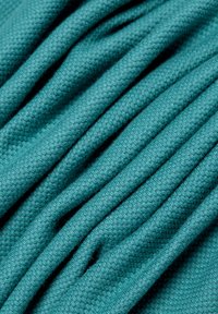 Textile fabric in a deep teal color, featuring a textured weave with visible folds and soft, lightweight material.