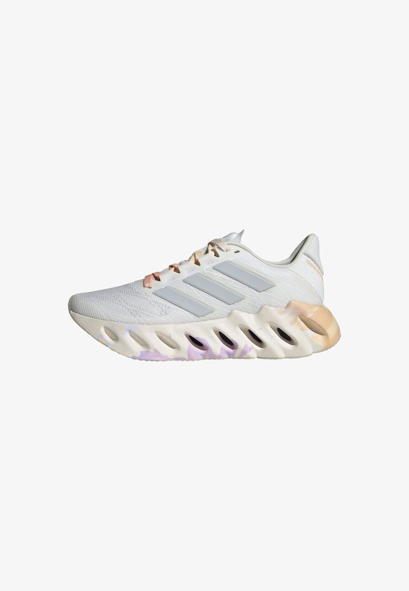 White athletic shoe featuring three gray stripes, a textured mesh upper, and a multi-colored, cushioned sole with cutouts.