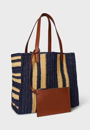 Torbica od slame s mornarskoplavim i bež prugastim uzorkom, smešane smeđe kožne ručke i priložena smešana smeđa kožna torbica. Teksturalni, prostrani dizajn.