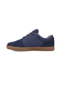 Navy blue sneakers with suede and synthetic materials, flat rubber sole, grey interior, and matching laces. Side ventilation holes present.