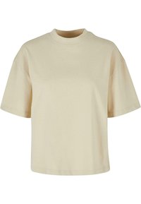 Camiseta de manga corta beige hecha de algodón suave. Presenta un cuello alto y un corte relajado con hombros caídos. Tejido simple y sólido sin patrones.
