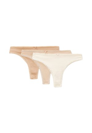 Trois sous-vêtements féminins bordés de dentelle en beige et blanc cassé, chacun avec un petit nœud sur la ceinture, disposés en rangée.