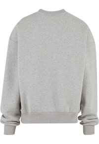 Grå oversized sweatshirt med rund halsudskæring, ribbede manchetter og kant. Stof ser blødt ud, med en glat tekstur og subtil melering.