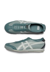 Sport shoes in teal and light gray leather, featuring a textured sole, rounded toe, and contrasting white stripes on the sides.