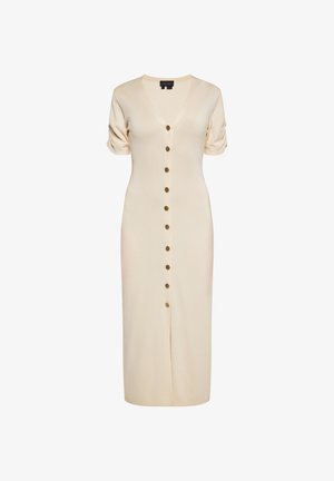 Térd hosszúságú, krémszínű ruha V-nyakkivágással, rövid puffos ujjal és elöl gombos záródással, arany gombokkal. Kötött anyagból készült.