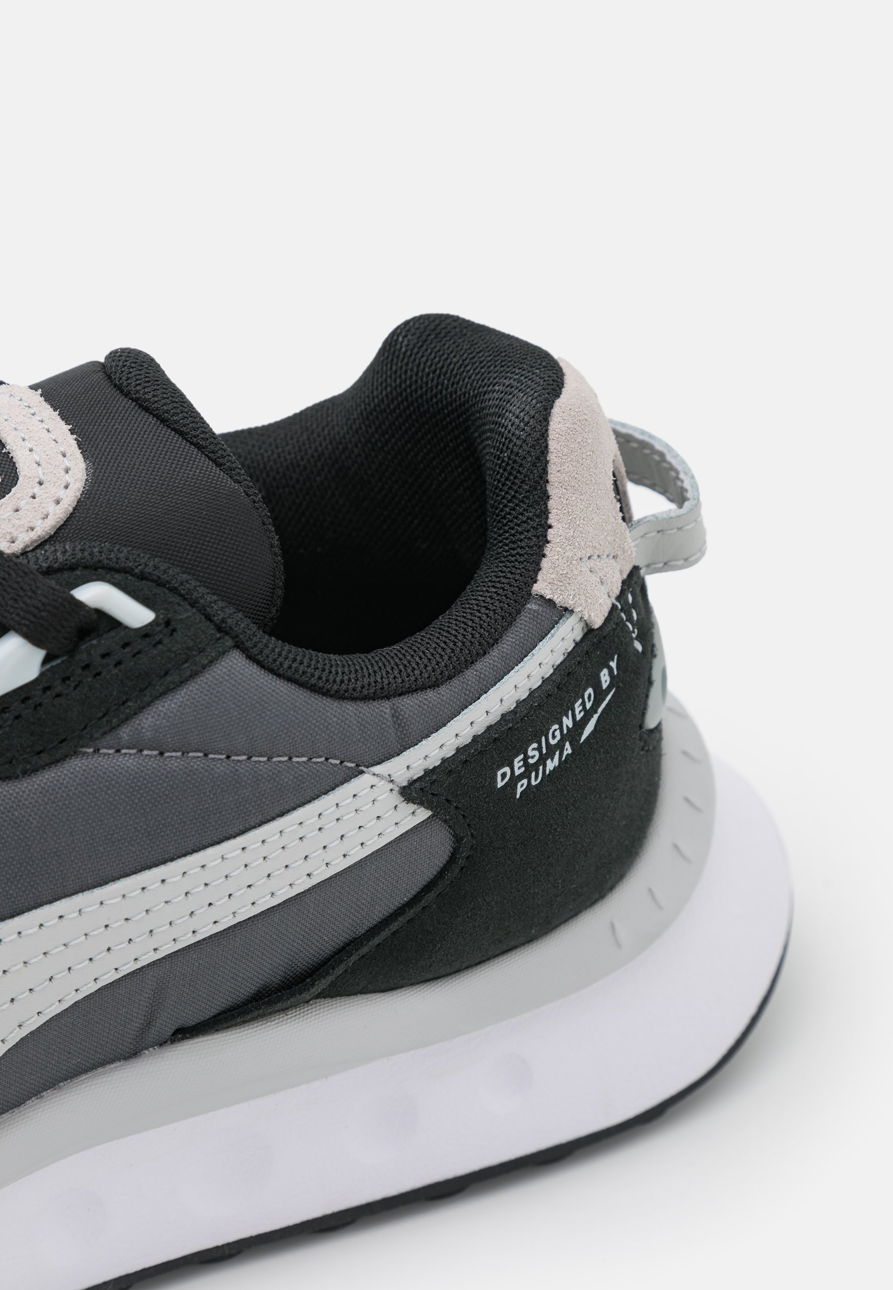 puma wild rider trainers in black and white
