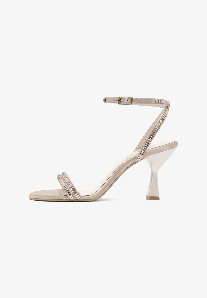 Nude high-heeled sandal with two horizontal straps and a buckled ankle strap. Features a curved block heel and textured accents.