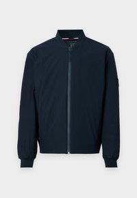 Giacca bomber leggera blu navy con zip frontale, colletto a costine e polsini elasticizzati. Tessuto morbido con design minimalista.
