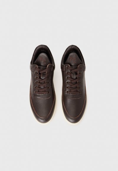 Brown leather sneakers with textured surface, contrasting stitching, rounded toe, and brown laces. Rubber outsole with slight platform.