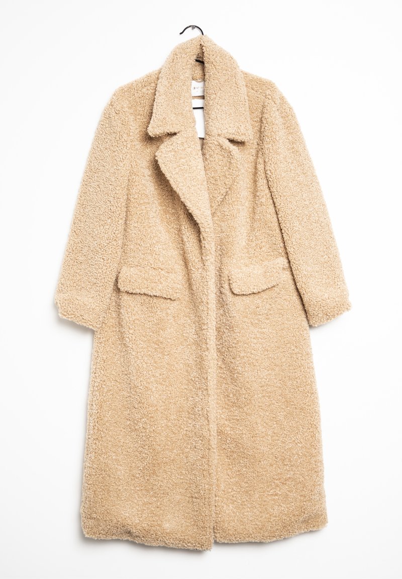 Beige teddy kabát s texturovaným, načechraným povrchem, s klopami a dvěma předními kapsami. Krátké rukávy a otevřený design.