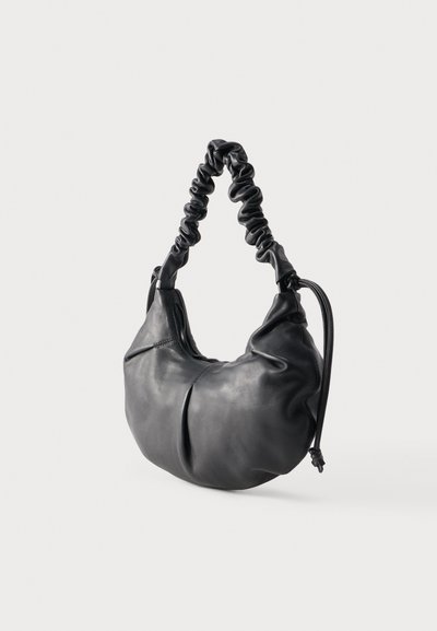 Black soft leather handbag with ruched shoulder strap and rounded, slouchy body against a plain background.