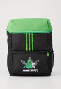 Zaino nero con parte superiore verde, caratterizzato da personaggi pixelati di Minecraft sulla parte frontale, dettagli verdi e tre strisce verticali verdi.