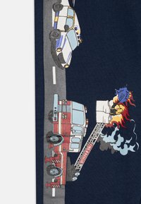 Red fire truck with ladder, blue police car, and flames depicted on a dark background. Cartoonish style with detailed vehicle features.