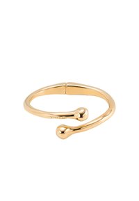 Bracelet en métal doré avec un design lisse et arrondi, présentant deux petits accents sphériques aux extrémités ouvertes.