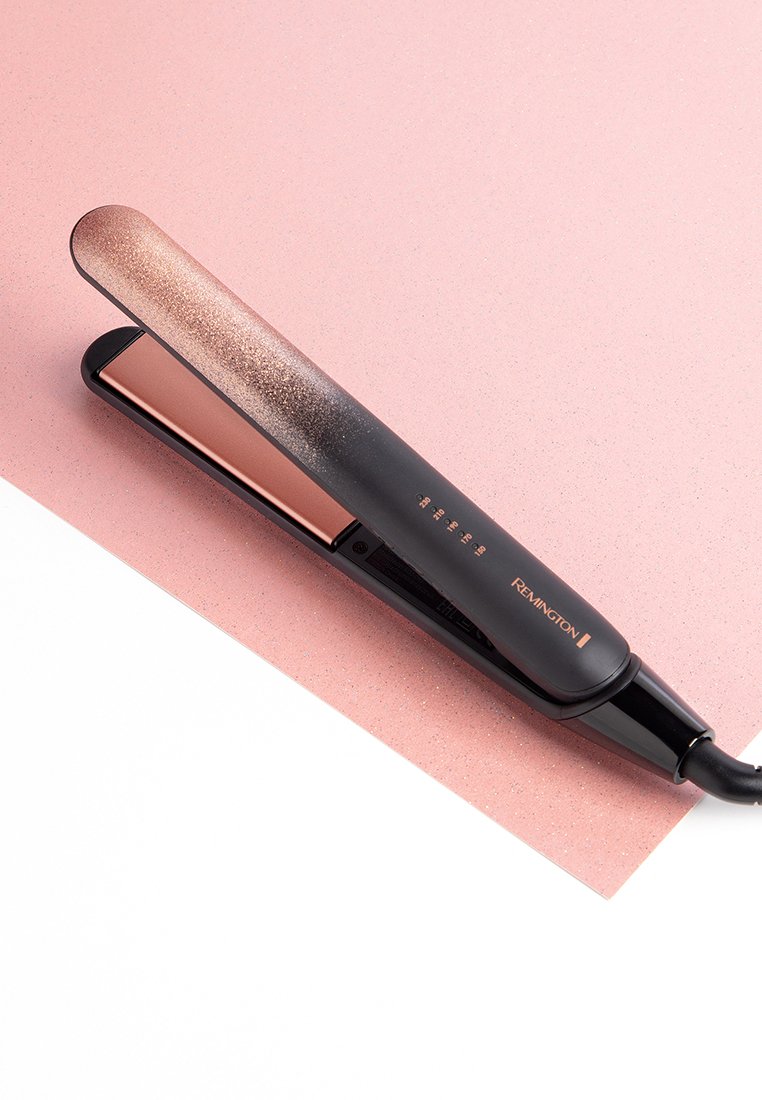Lisseur de cheveux noir et rose doré avec un design dégradé, plaques lisses, réglages de température numériques et un cordon d'alimentation flexible.