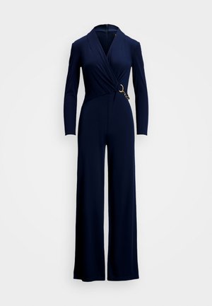 Marineblå jumpsuit med lange ermer, design med omslag foran og et gullfarget metalltilbehør i midjen. Glatt, elastisk stoff, silhuett med vide ben.