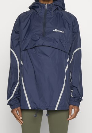 Navy windbreaker jacket featuring a half-zip front, a hood, reflective silver accents, elastic cuffs, and adjustable drawstring at the hem.