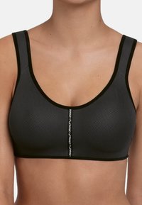 Sort sports-bh lavet af mesh-materiale. Brede stropper, rund halsudskæring og sømdetaljer med et logo i midten foran.