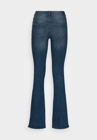 Dark blue denim bootcut jeans shown from the back with two rear pockets and visible stitching on a white background.