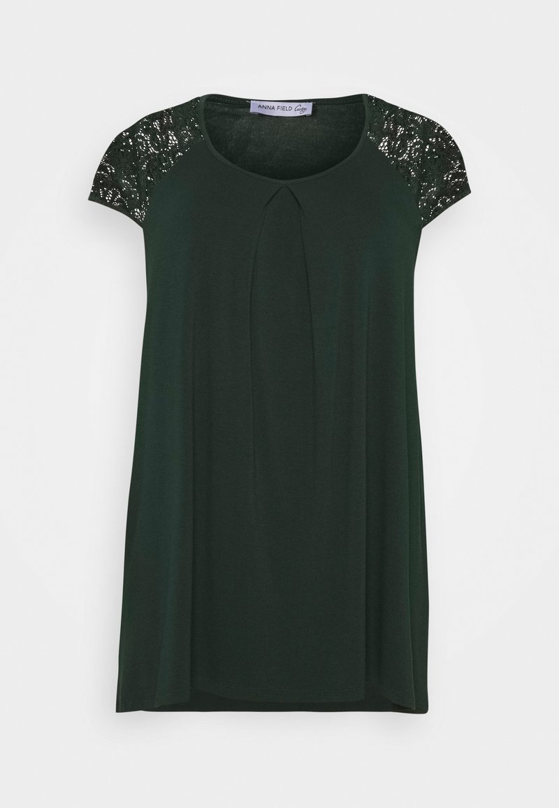 Dark green top featuring short sleeves made of lace, a round neckline, and pleated detail at the front. Made of soft fabric.