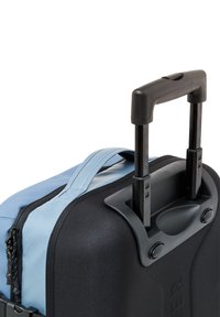 Black wheeled carry-on bag with a light blue top panel, retractable black handle, textured fabric, and contrasting zipper detailing.