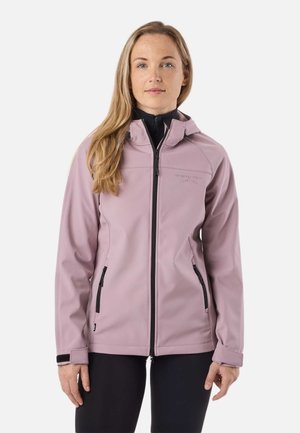Femme aux longs cheveux blonds portant une veste softshell zippée violet clair à capuche et un legging noir, face à l'avant sur un fond blanc.