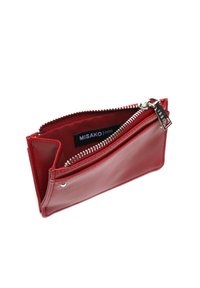 Červená kožená peňaženka na mince so strieborným zipsom, čiastočne otvorená, odhaľujúca vnútornú nálepku s nápisom "MISAKO".