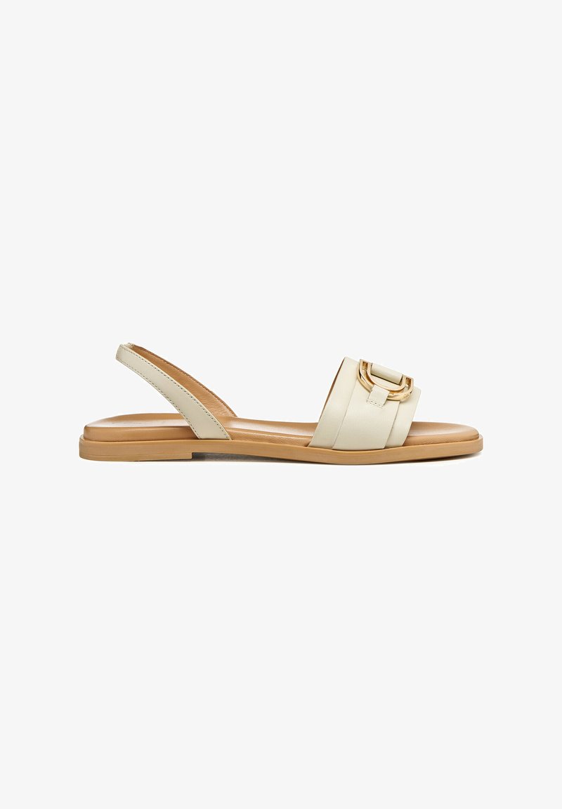 Cream-colored slingback sandal with a wide strap, decorative buckle, flat sole, and smooth leather texture. Minimalist design with neutral tones.