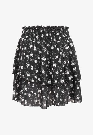 Schwarzer mehrlagiger Rock mit weißem kleinem Blumenmuster und gerafftem elastischem Bund.