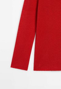 Red knitted sweater with long sleeves and a soft texture, featuring a straight-cut hem and no visible hardware or patterns.