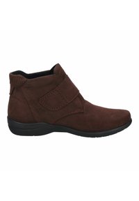 Brune ruskind ankelstøvler med velcrorem, der har tonalt syning og en sort gummisål, bøjet design og en struktureret finish.