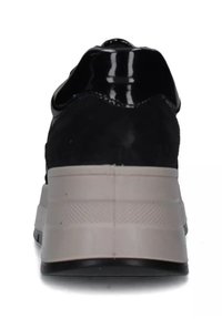 Sneaker in suede nero con dettagli lucidi neri, suola intermedia grigia spessa e suola esterna in gomma nera testurizzata. Design a profilo basso vista dal retro.