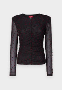 Svart långärmad topp i genomskinligt material med röda hjärtmönster, rund halsringning och rynkad detaljering över framsidan.