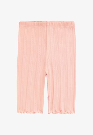 Leggings de color rosa claro hechos de tela acanalada y texturizada con pequeños patrones de ojales; cuentan con una cintura elástica y un dobladillo con borde ondulado.