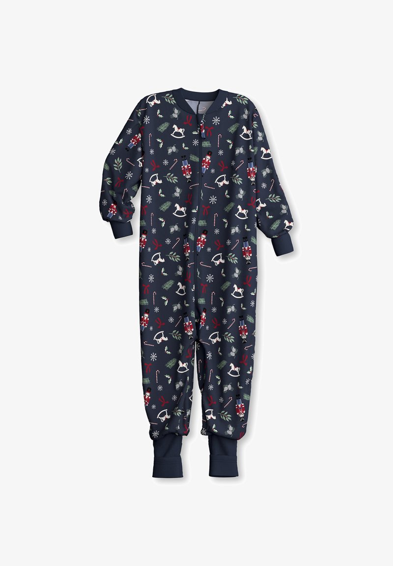 Navy one-piece pajama with long sleeves and zipper; features festive patterns of nutcrackers, snowflakes, and holiday elements in red and green.
