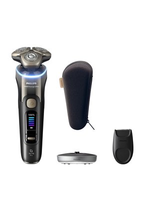 Philips electric shaver with triple rotary heads, digital display, travel case, charging stand, and trimmer attachment on white background.