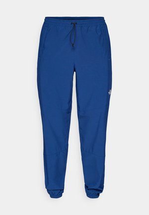 Blue lightweight jogger pants with an elastic waistband, drawstring, and elastic cuffs. Features side pockets and a logo near the lower leg.