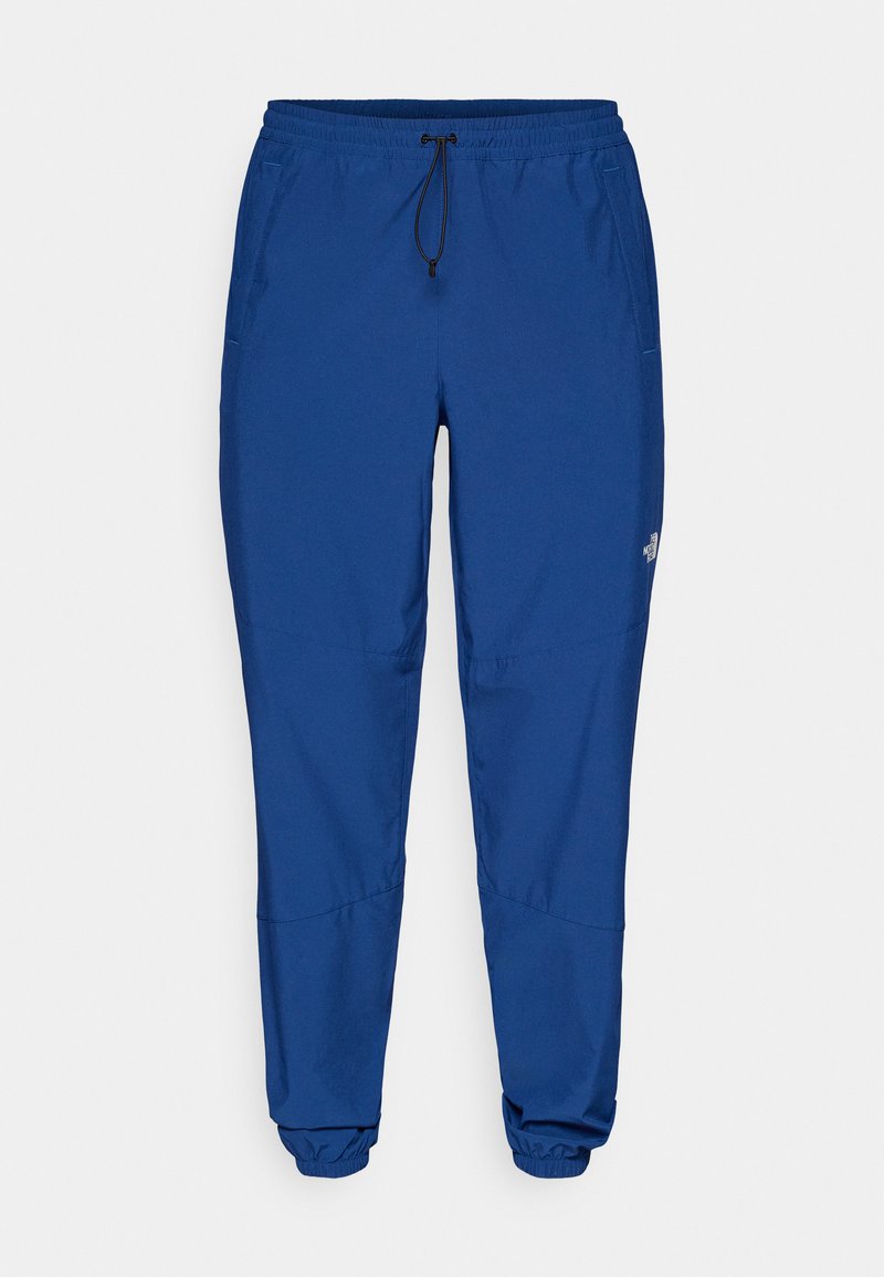 Leichte blaue Jogginghose mit einem elastischen Bund, Kordelzug und elastischen Bündchen. Mit Seitentaschen und einem Logo am unteren Bein.
