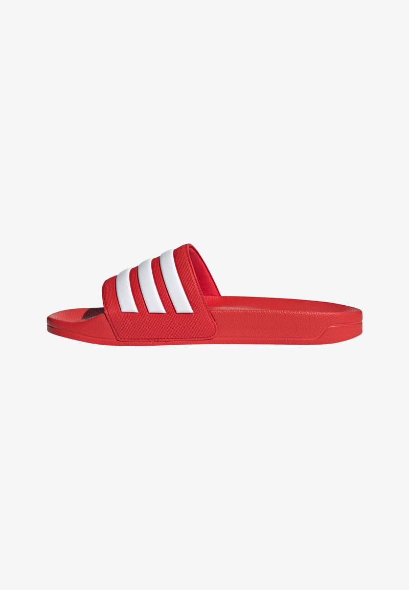 Red slide sandals made of synthetic material with a textured strap featuring three white stripes, flat sole, and rounded toe.