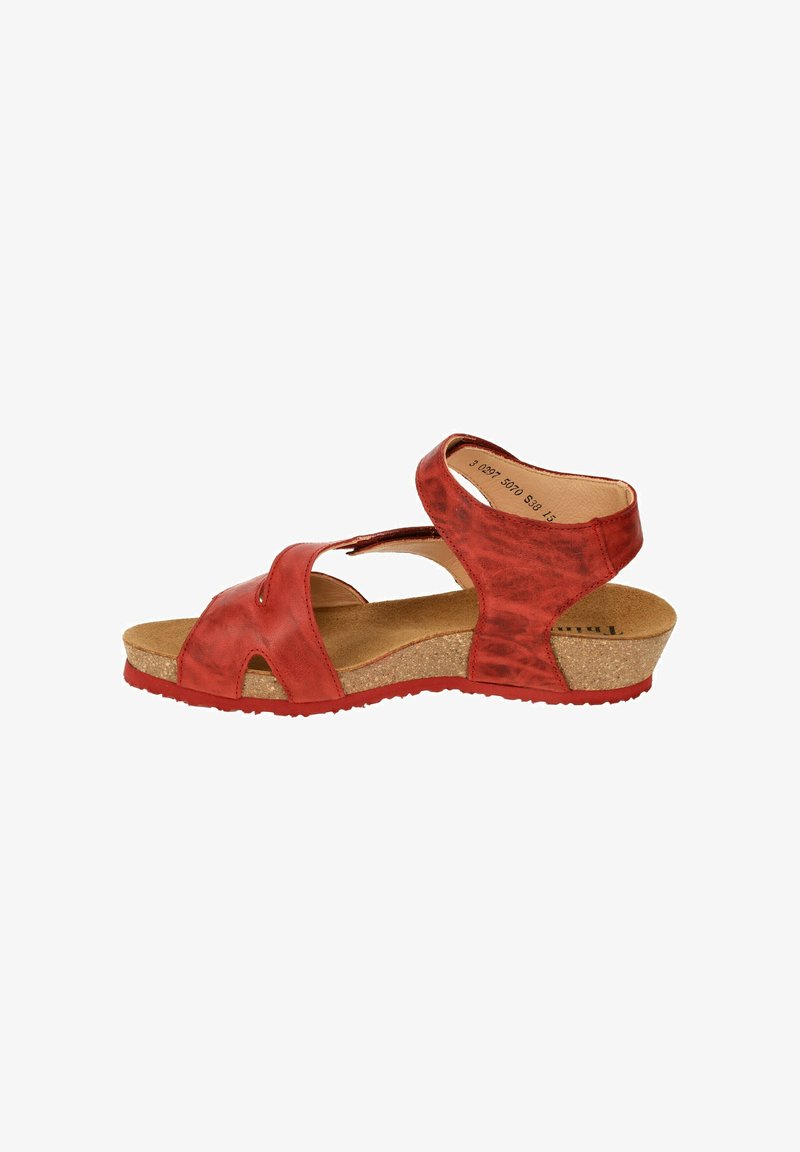 Red leather sandal with a wedge cork sole, featuring cut-out designs and adjustable straps for secure fit. Textured upper with smooth finish.