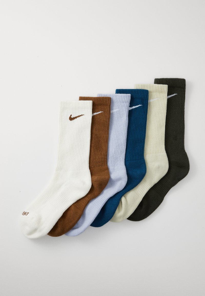 Six pairs of ribbed socks in white, brown, light blue, teal, light green, and dark green, featuring a Nike logo on each pair.