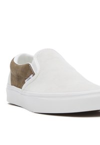 Sneaker slip-on in suede bianco con accenti in suede marrone chiaro, tomaia testurizzata e suola in gomma bianca. Finitura liscia e design elegante.