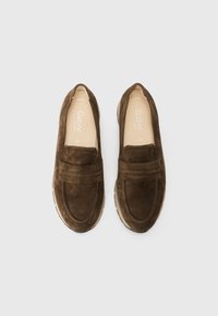 Brown suede loafers with a rounded toe, featuring a decorative stitch design and a textured rubber sole for comfort.