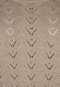 Beige knitted fabric featuring a diamond pattern with small triangular cutouts and contrasting textural lines.