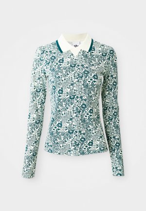 Hosszú ujjú, testhez simuló ing teal és fehér virágmintával, fehér gallérral, teal szegéllyel, egy sima háttér előtt.